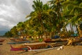 A small outrigger style Banca boat rests on a tropical beach.Pandan, Panay, Philippines. Royalty Free Stock Photo