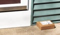 Small package delivered and left on front pourch Royalty Free Stock Photo