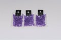 Small packs of shiny silver lined purple glass beads