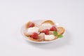 Small pancakes with cream and strawberries