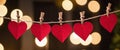 small panoramic paper Red hearts hanging on a string as a decoration