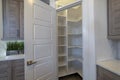 Small pantry with empty wall shelves at the corner of the kitchen of home