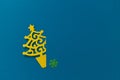 Small paper cut Christmas tree on blue background