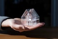 a small paper model house in the hand of a person Royalty Free Stock Photo