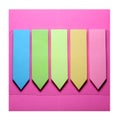 Small paper notebooks in the shape of colored arrows on a pink background. Paper notice board with blank labels in basic colors.