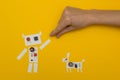Small paper robot holding a man`s hand