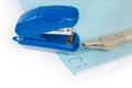Small paper stapler and staple remover on stapled paper sheets Royalty Free Stock Photo