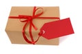 Small parcel or gift tied with red ribbon and gift tag isolated on white background, closeup Royalty Free Stock Photo