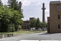 Small park with fountain dwarfed by tall smoke stacks