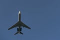 Small passenger aircraft with engines in the tail unit against the blue sky.