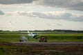 Small passenger Maya Island Air aircraft landing in remote Orange Walk airport in the middle of the sugar cane plantation