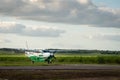 Small passenger Maya Island Air aircraft landing in remote Orange Walk airport in the middle of the sugar cane plantation