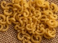 Small pasta close-up on the burlap. Carbohydrate food. Royalty Free Stock Photo