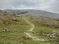 Small path in a mountains, cloudy sky, Burren National Park, Ireland. Concept travel, hiking, outdoors