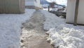 small path opened in the snow, which gives access to a school in a mountain town