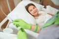 Small patient lies under a dropper on a hospital bed Royalty Free Stock Photo