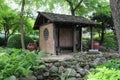 A small pavilion in a Japanese Garden filled with ferns, plants, shrubs and trees in Janesville, Wisconsin