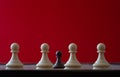 Small pawn on chess board against larger adversary concept of adversity ,discimination ,equality Royalty Free Stock Photo