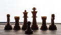 Small pawn on chess board against larger adversary concept of adversity ,discimination ,equality .focus on forground