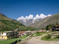 Small, peaceful Keylong village on Manali Leh rooad with mountains and blue sky background Royalty Free Stock Photo