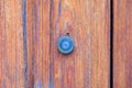 A small peephole in a wooden door. Royalty Free Stock Photo