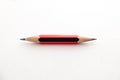 A small pencil, sharpened at both ends, on a white background