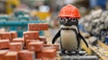 A small penguin wearing a hard hat on top of train tracks, AI