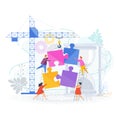 Small people put the pieces of the puzzle together. Royalty Free Stock Photo