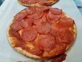 small pepperoni pizza with slices of salami meat Royalty Free Stock Photo