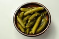 Small pickled cucumbers in brine according to a traditional recipe, served in a ceramic bowl Royalty Free Stock Photo