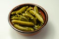 Small pickled cucumbers in brine according to a traditional recipe, served in a ceramic bowl Royalty Free Stock Photo