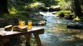 A small picnic table by a clear stream with fresh sandwiches and Royalty Free Stock Photo