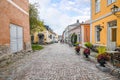 A small, picturesque, and colorful cobblestone street of shops and cafes in the medieval village of Porvoo, Finland Royalty Free Stock Photo