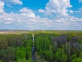 Small picturesque forest river, aerial view. Beautiful cloudy sky over the forest Royalty Free Stock Photo