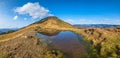 Small picturesque lake with clouds reflections at the  Strymba Mount. Beautiful autumn day in Carpathian Mountains near Kolochava Royalty Free Stock Photo