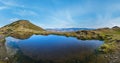 Small picturesque lake with clouds reflections at the Strymba Mount. Beautiful autumn day in Carpathian Mountains near Kolochava Royalty Free Stock Photo