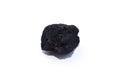 A small piece of black coal on a white background Royalty Free Stock Photo