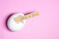 It's a girl hand written in brown sheet piece and kept it inside white broken eggshell in pink background Royalty Free Stock Photo