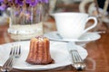 Small piece of canele serve in a plate on the table in tea shop