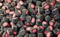small pieces of licorice filled with colored sugar