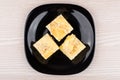 Small pieces of pie in black glass plate, top view Royalty Free Stock Photo