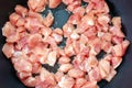 Small pieces of pork meat are fried in a pan in olive oil. close up selective focus Royalty Free Stock Photo