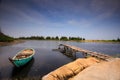 Small pier with boat in a pond