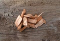 Small group of alder smoking chips for barbecuing on a wood background