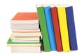 Small pile leaning row of colorful books isolated on white