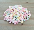 Small pile of pastel butter mints on a wood background Royalty Free Stock Photo