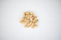 Small pile of peanuts in shell isolated on white table Royalty Free Stock Photo