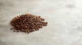 A small pile of roasted coffee beans on a neutral table with space for branding pic Royalty Free Stock Photo