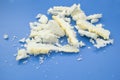 A small pile of scraps of construction foam on a blue background Royalty Free Stock Photo