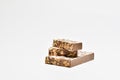 A small pile of tempting chocolate and almonds nougat on a light background